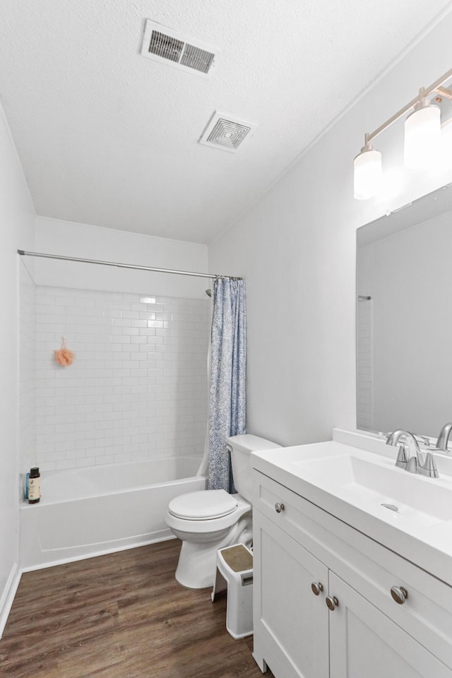 7696 Brandywine Rd, North Charleston, SC 29420 - bathroom with vanity, wood finished floors, shower / bathtub combination with curtain, and a textured ceiling