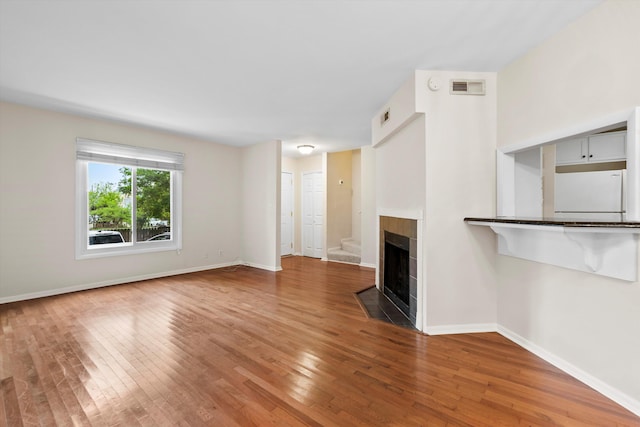 22 Ogier St, Charleston, SC 29403 - unfurnished living room with wood-type flooring and a fireplace