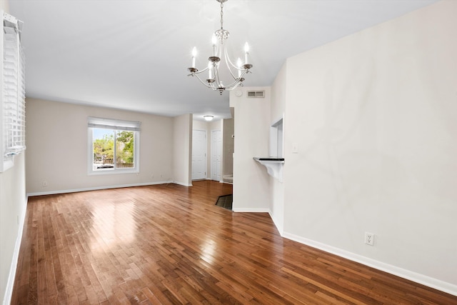 22 Ogier St, Charleston, SC 29403 - unfurnished living room featuring a chandelier and hardwood / wood-style flooring