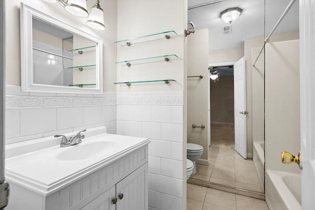 22 Ogier St, Charleston, SC 29403 - bathroom with vanity, shower / bath combination, tile patterned flooring, a wainscoted wall, and tile walls