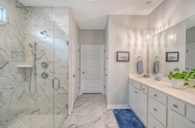 bathroom featuring a shower with door and vanity