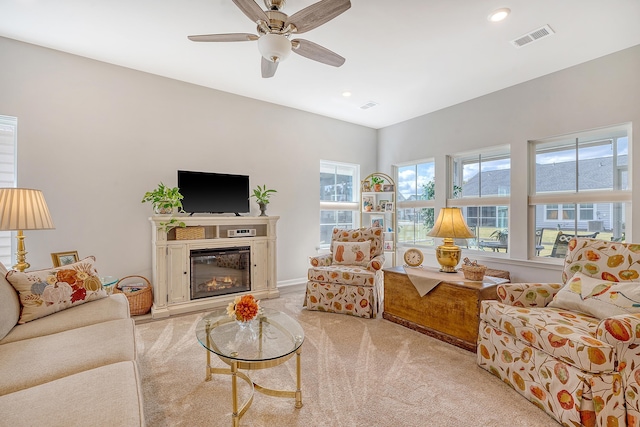 carpeted living room featuring ceiling fan