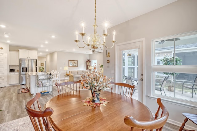 dining room featuring a chandelier and light hardwood / wood-style flooring