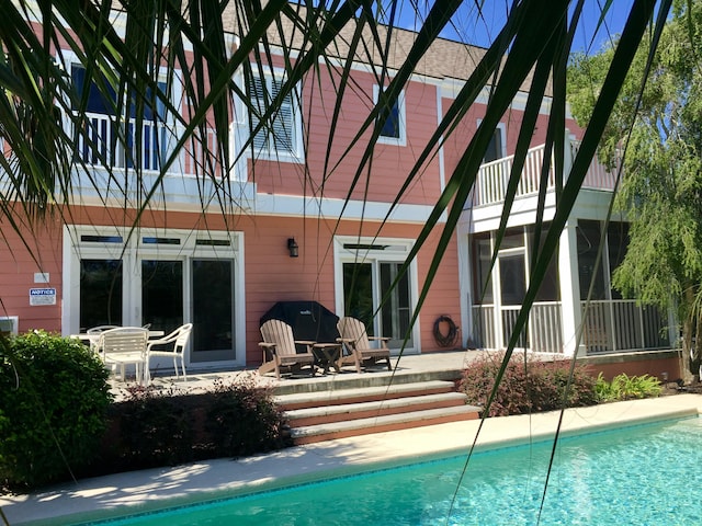 back of house featuring an outdoor pool