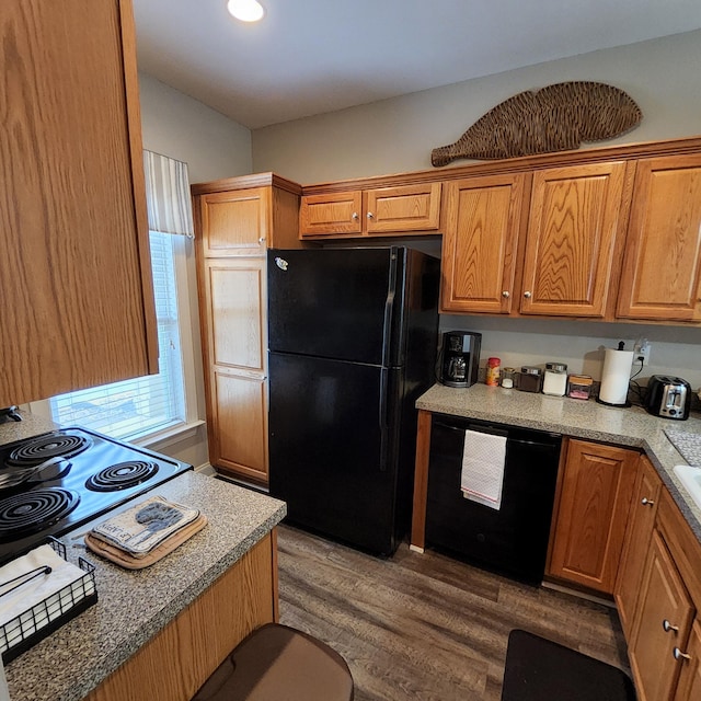 kitchen with hardwood / wood-style flooring and black appliances