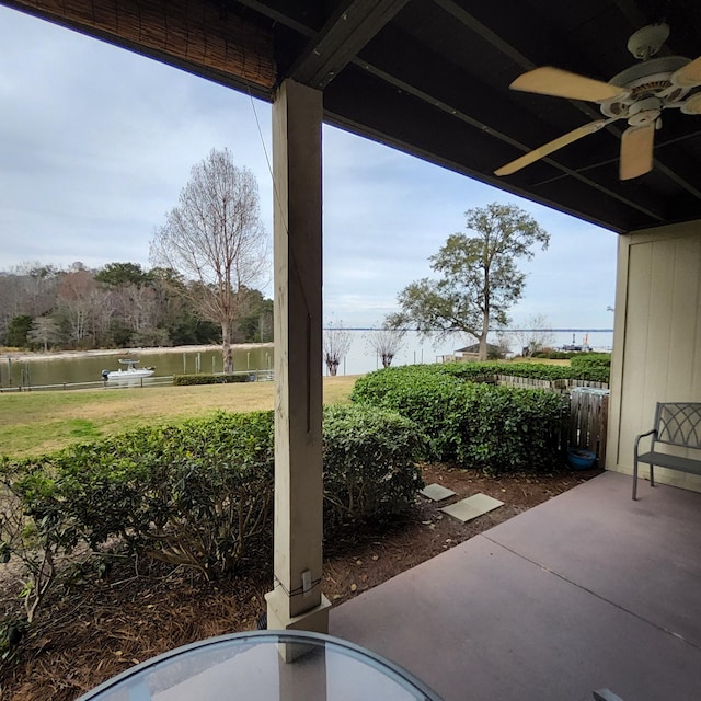 view of patio / terrace featuring ceiling fan and a water view