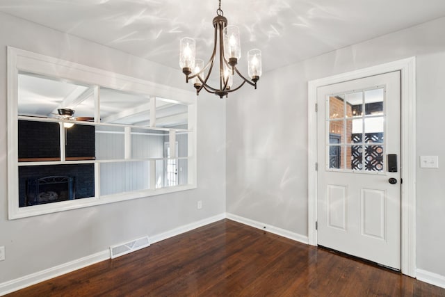 unfurnished dining area featuring visible vents, baseboards, plenty of natural light, and dark wood finished floors