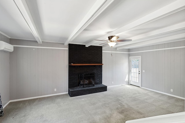 unfurnished living room featuring beamed ceiling, a ceiling fan, a wall unit AC, carpet, and a brick fireplace