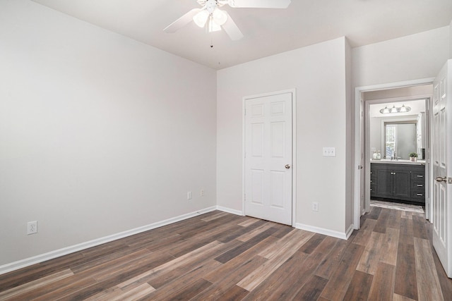 unfurnished bedroom featuring ceiling fan, a closet, and dark hardwood / wood-style floors