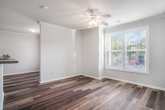 empty room featuring dark hardwood / wood-style flooring, ceiling fan, and ornamental molding