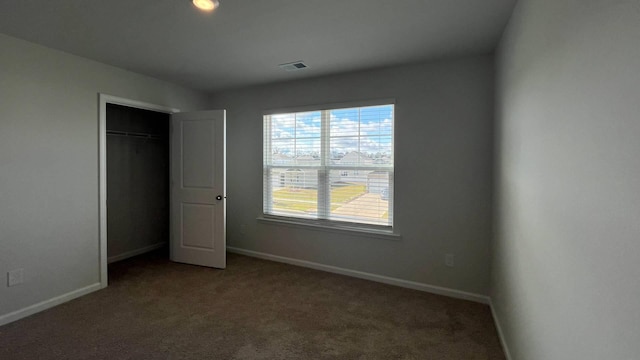 unfurnished bedroom with carpet floors and a closet