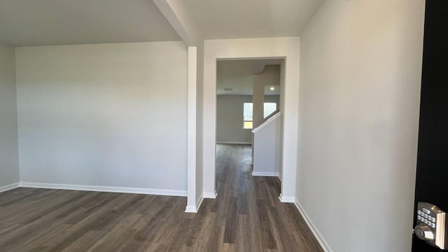 corridor with dark hardwood / wood-style flooring