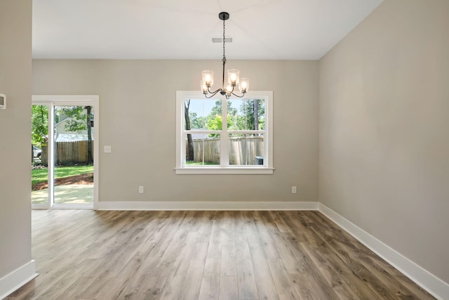 2960 Blackfish Rd, Johns Island, SC 29455 - empty room with a chandelier, wood finished floors, and baseboards