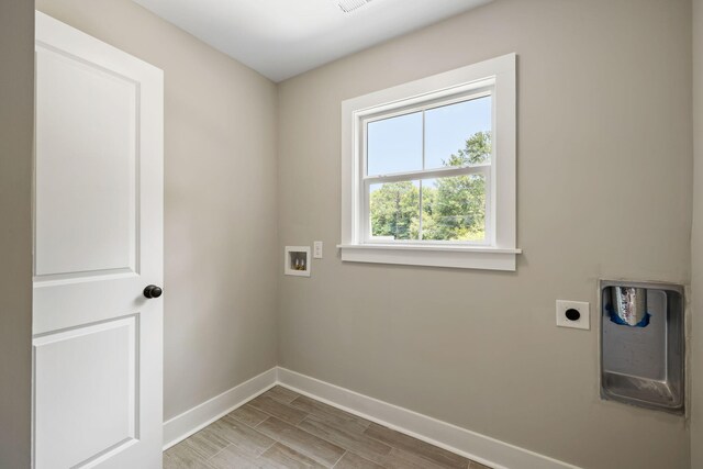 2960 Blackfish Rd, Johns Island, SC 29455 - laundry room with hookup for an electric dryer, baseboards, hookup for a washing machine, and light wood-style floors