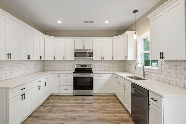 2960 Blackfish Rd, Johns Island, SC 29455 - kitchen with stainless steel appliances, a sink, white cabinetry, recessed lighting, and tasteful backsplash