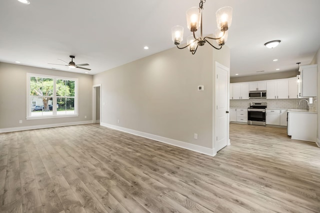 2960 Blackfish Rd, Johns Island, SC 29455 - unfurnished living room with a ceiling fan, light wood-style flooring, a chandelier, a sink, and recessed lighting