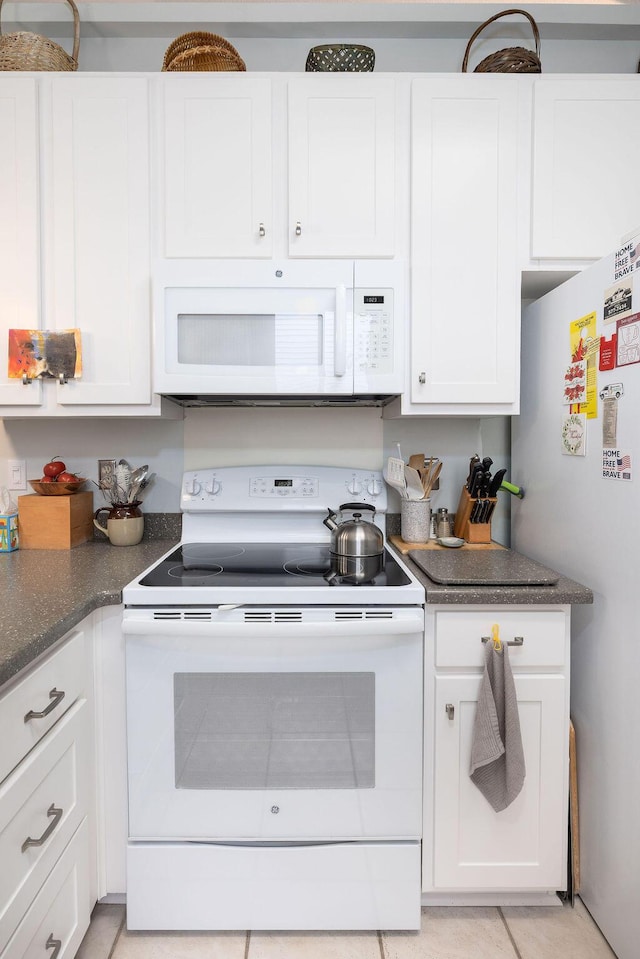 1578 Harborsun Dr, Charleston, SC 29412 - kitchen with light tile patterned floors, white appliances, white cabinets, and dark stone countertops