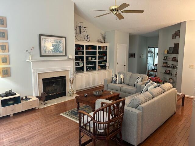 1578 Harborsun Dr, Charleston, SC 29412 - living area featuring a fireplace with flush hearth, ceiling fan, vaulted ceiling, and hardwood / wood-style flooring