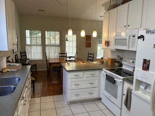 1578 Harborsun Dr, Charleston, SC 29412 - kitchen with a peninsula, visible vents, white appliances, and a healthy amount of sunlight