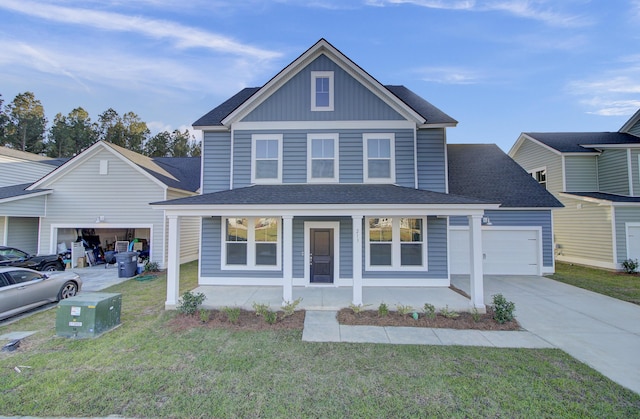view of front facade with roof with shingles, a porch, driveway, a front lawn, and a garage