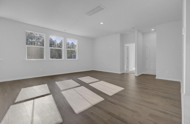 spare room with wood finished floors, recessed lighting, and baseboards