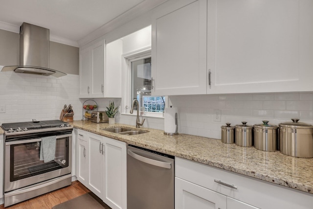 kitchen with white cabinetry, appliances with stainless steel finishes, sink, and range hood