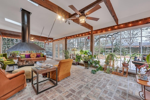 sunroom / solarium with beamed ceiling and ceiling fan