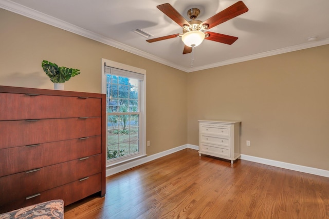 unfurnished bedroom with crown molding, ceiling fan, and light wood-type flooring