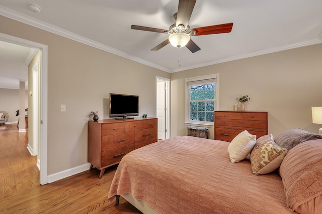 bedroom featuring crown molding, ceiling fan, and light wood-type flooring