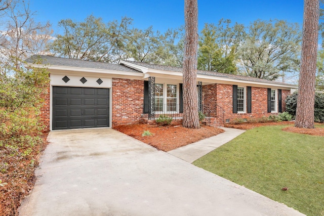 single story home featuring a garage and a front yard