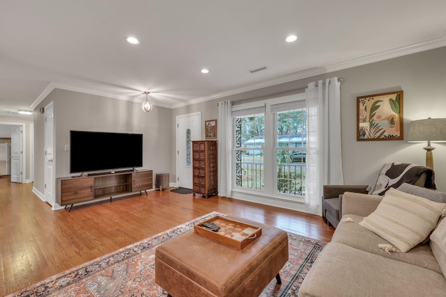 living room featuring ornamental molding and hardwood / wood-style floors