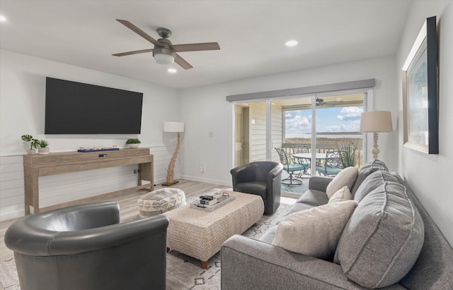 living room with ceiling fan and light wood-type flooring