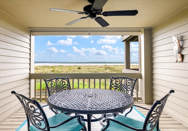 balcony featuring ceiling fan and a water view