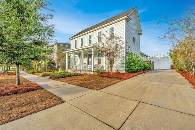 view of front of property featuring covered porch, an outdoor structure, and a garage