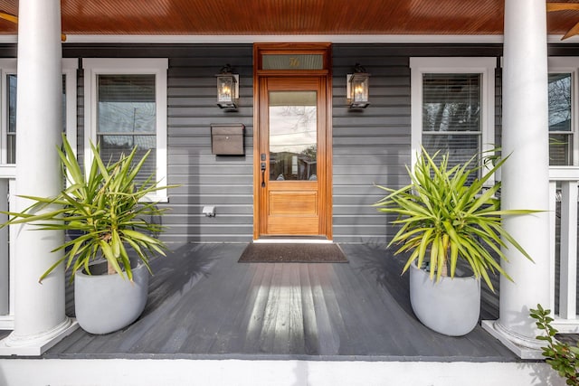 view of exterior entry featuring a porch