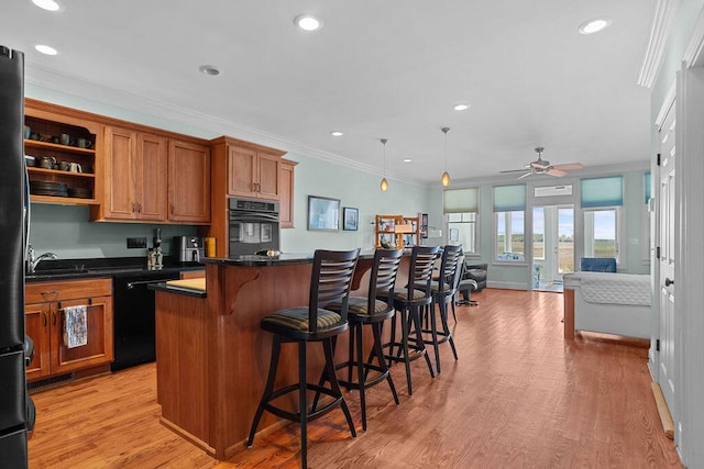 kitchen featuring dishwashing machine, brown cabinetry, ornamental molding, oven, and light wood-type flooring