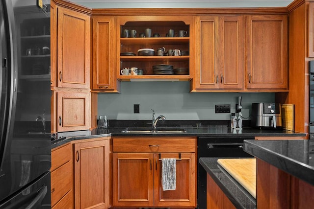 kitchen featuring a sink, black appliances, and brown cabinetry