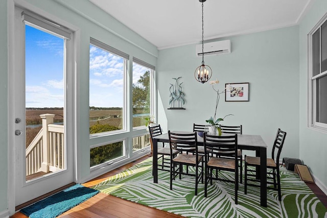 sunroom featuring a chandelier and a wall mounted air conditioner