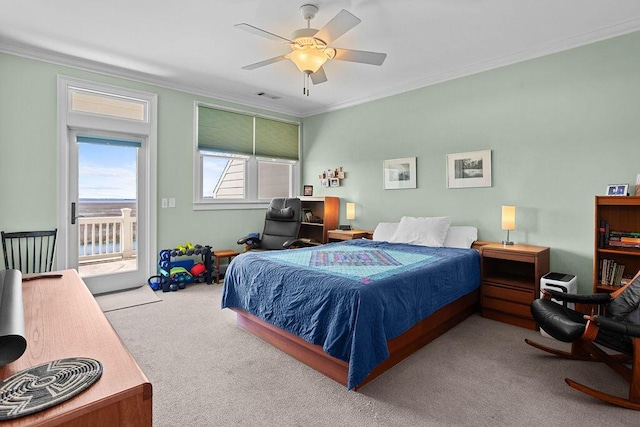 carpeted bedroom featuring crown molding, access to outside, a ceiling fan, and visible vents