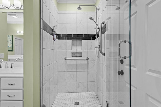 full bath featuring a shower stall, vanity, and crown molding