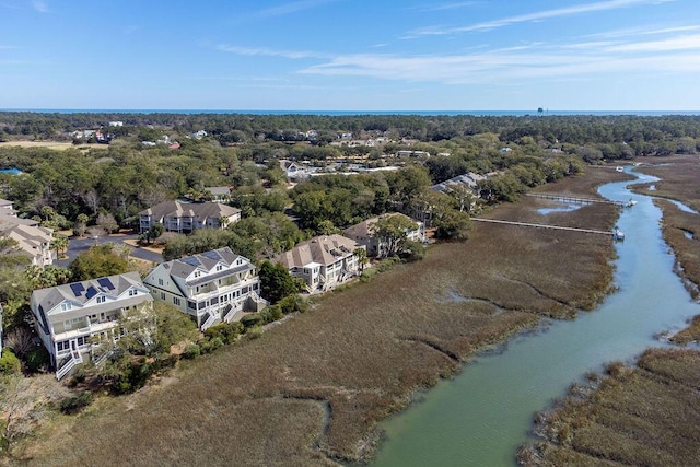 birds eye view of property featuring a wooded view and a water view