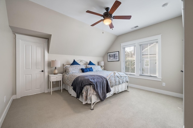 bedroom featuring vaulted ceiling, baseboards, visible vents, and light colored carpet