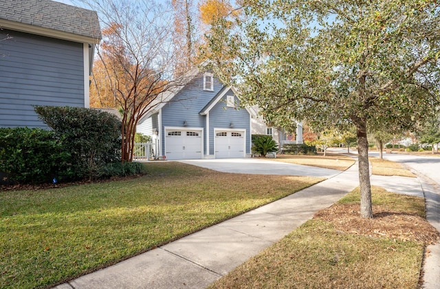 exterior space with an attached garage, a lawn, concrete driveway, and roof with shingles