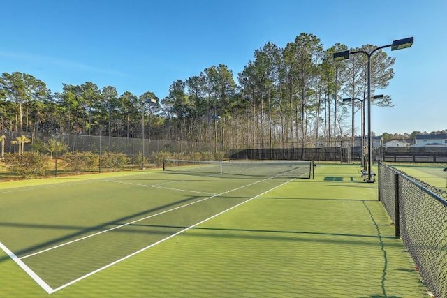 view of sport court with fence