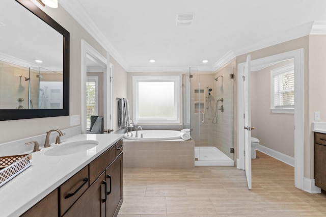 full bathroom featuring a garden tub, toilet, vanity, ornamental molding, and a stall shower