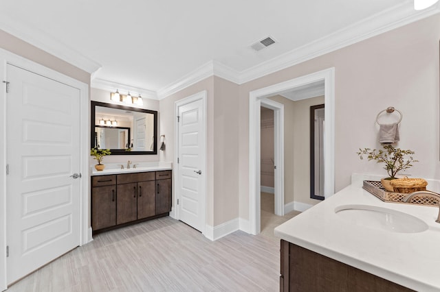 bathroom with two vanities, visible vents, a sink, and wood finished floors