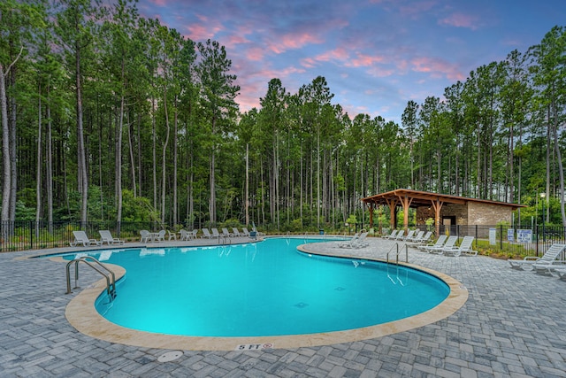 pool featuring a patio area and fence