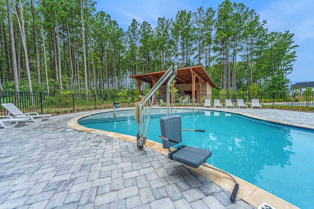 community pool featuring a gazebo, a patio area, and fence