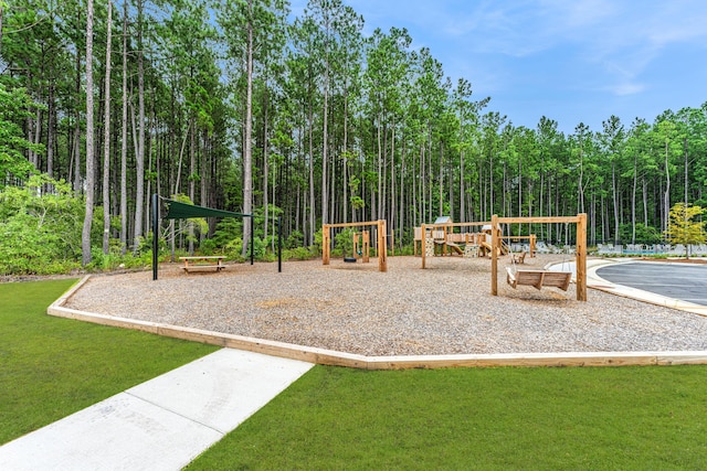 community jungle gym featuring a lawn