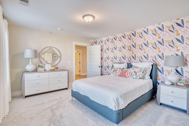 carpeted bedroom featuring baseboards and visible vents